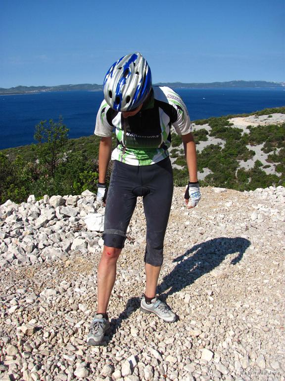 Slika_092.jpg - Hja, kaj naj rečem, spet sem cviknila. Že tako sem imela malo nasekano gumo in nisem hotela riskirat, ampak je ravno počasna vožnja botrovala spektakularnemu padcu. Jure je čakal v naslednjem ovinku, da mi pove, kje je lani gumo pupmal, pa se je le odločil pogledat kaj počnem. Ravno malo je zamudil tole sceno: jaz na desnem boku, čevelj še vedno zapet na pedalu, zadnjica ujeta pod sedežem, balanca pa mi je zvita čisto na desno ukleščila koleno. Pobiranje je bilo kot reševanje gordijskega vozla.
