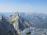 Odpre se nama pogled na vršace nad Bovcem in Trento.  V ospredju verjetno Pelc nad Klonicami s svojimi 2442 m. Ni slabo, pa še markirana pot je nanj!